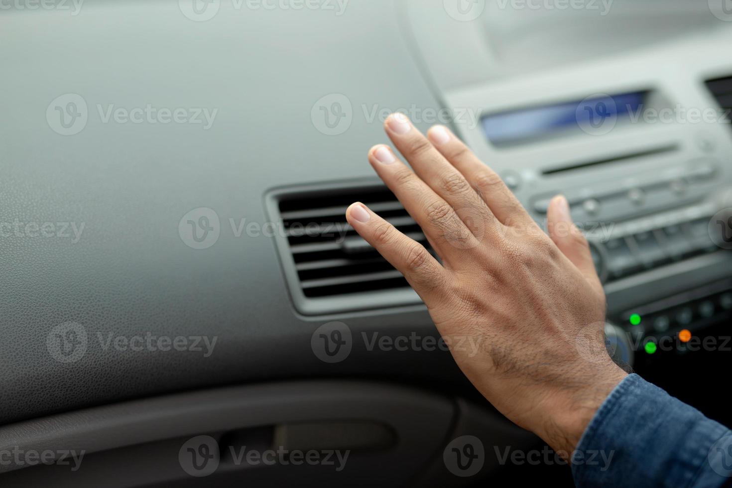 Closeup of hand driver man checking adjusting air from conditioning the cooling system with flow of cold air in car. Leave space for writing text. photo
