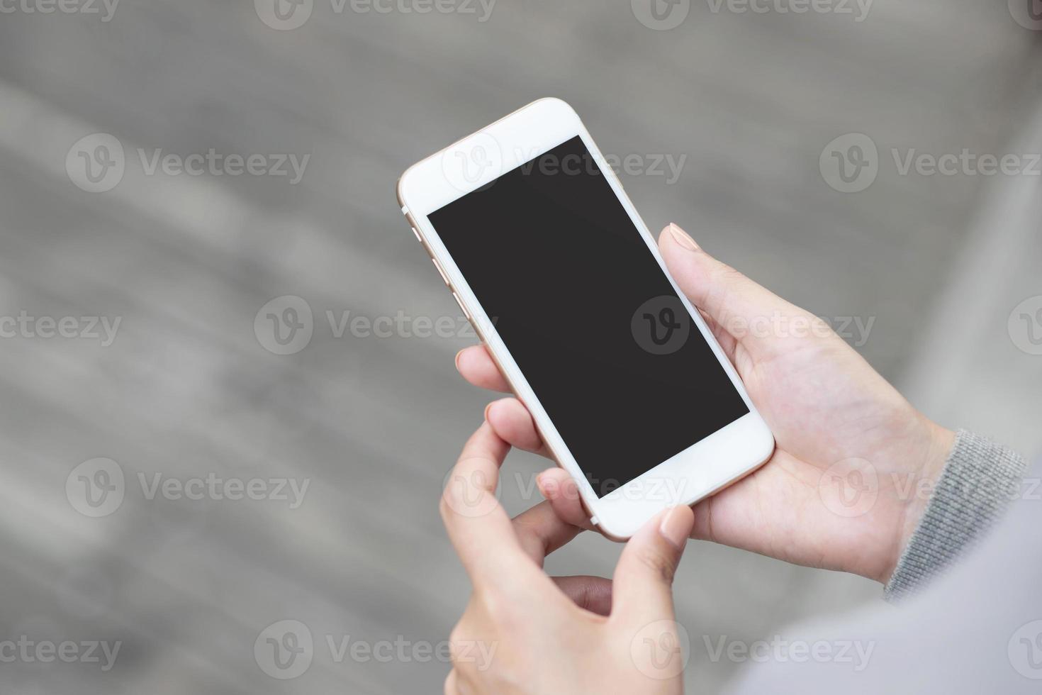 Lifestyle  close up hand young woman in watching message on mobile smart phone during break. using cell phones to communicate in the online world. with blank or empty black screen photo