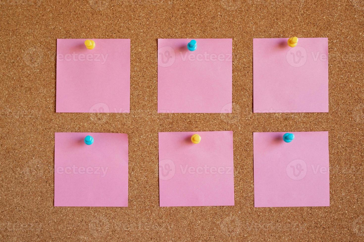 collection of colorful variety. paper note pad reminder sticky notes pin paper yellow on cork bulletin board photo