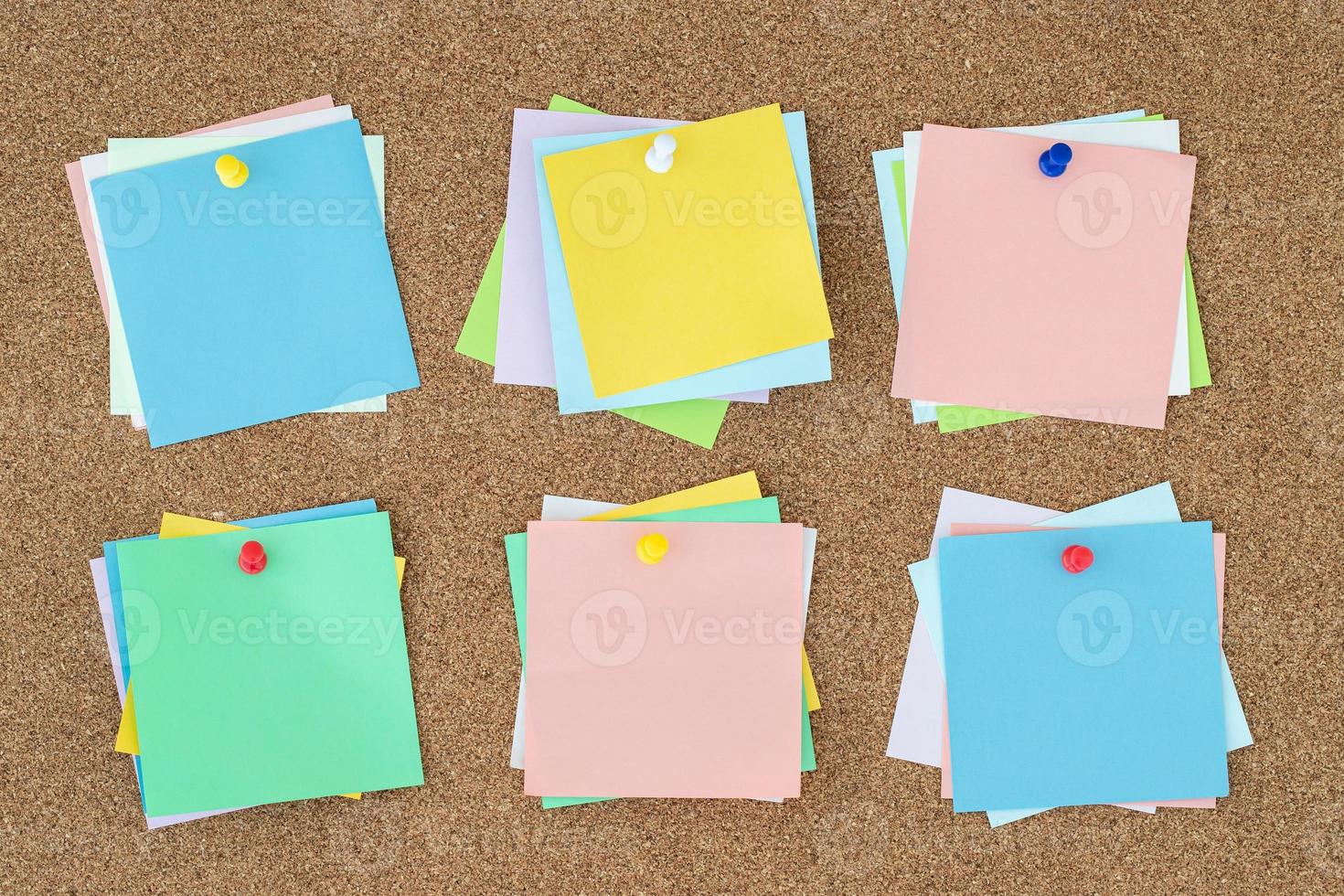collection of colorful variety post. paper note reminder sticky notes pin on cork bulletin board. photo