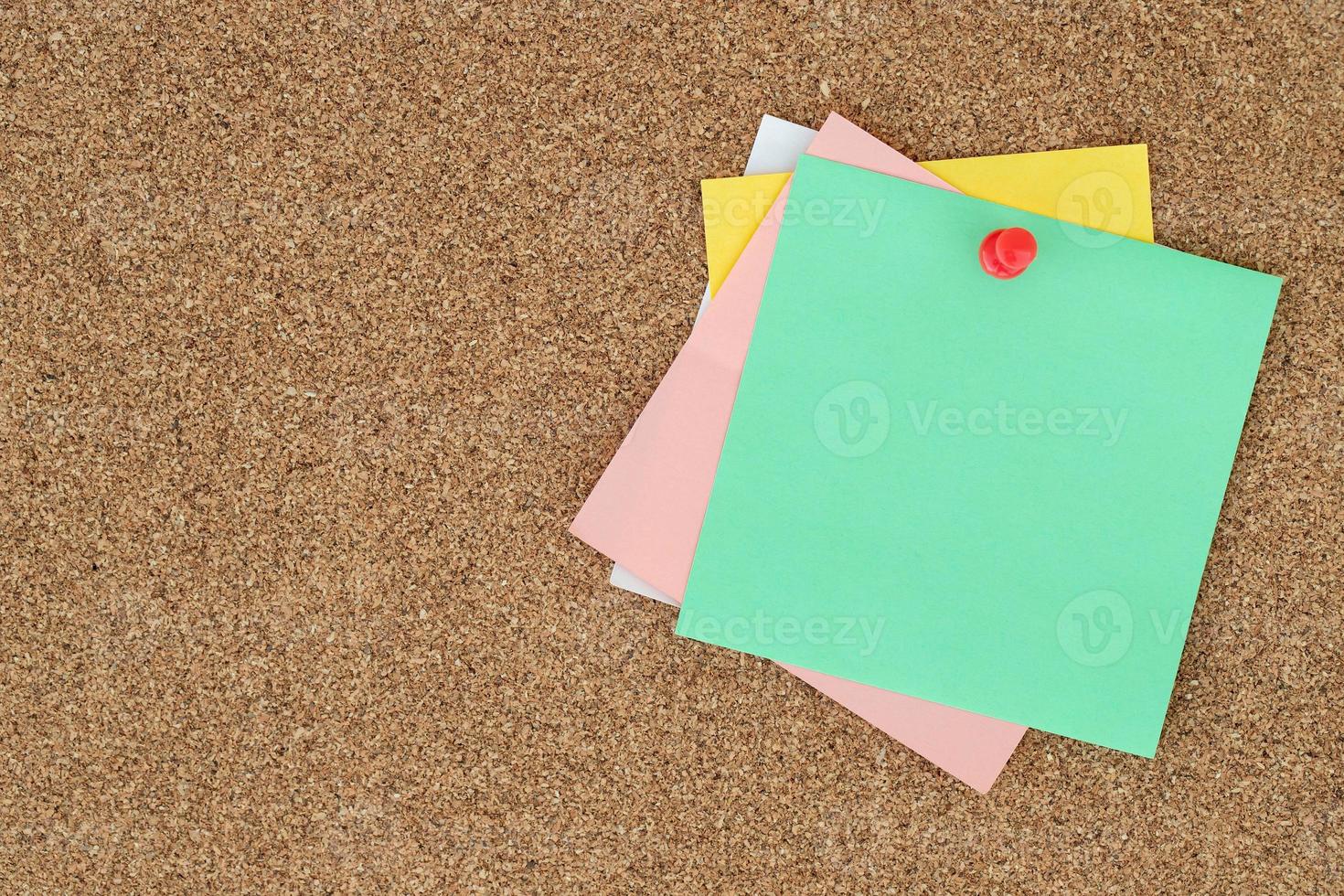 collection of colorful variety post. paper note reminder sticky notes pin on cork bulletin board. photo