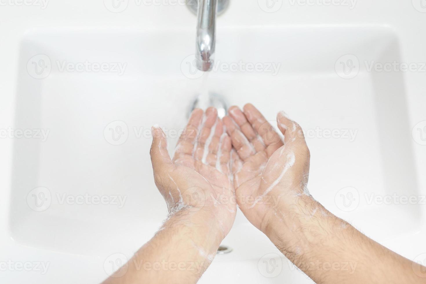 Hygiene. Cleaning Hands. Washing hands with soap under the faucet with water Pay dirt. top view. photo