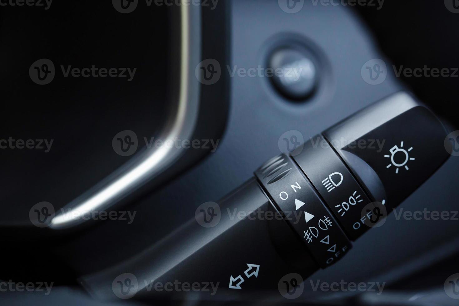 close up person hand of windshield wiper switch control in interior car. photo