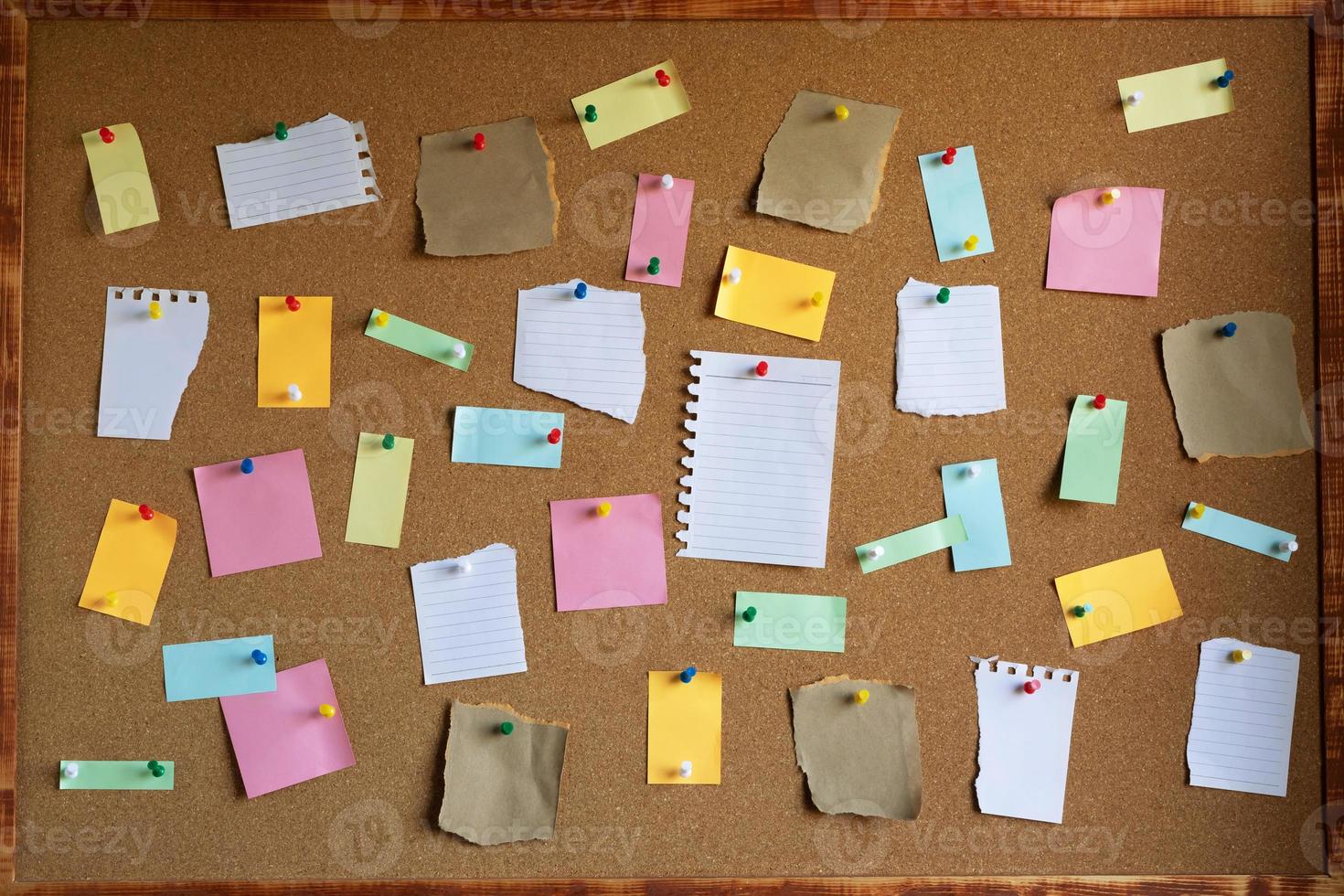 collection of colorful variety. paper note pad reminder sticky notes pin paper yellow on cork bulletin board photo