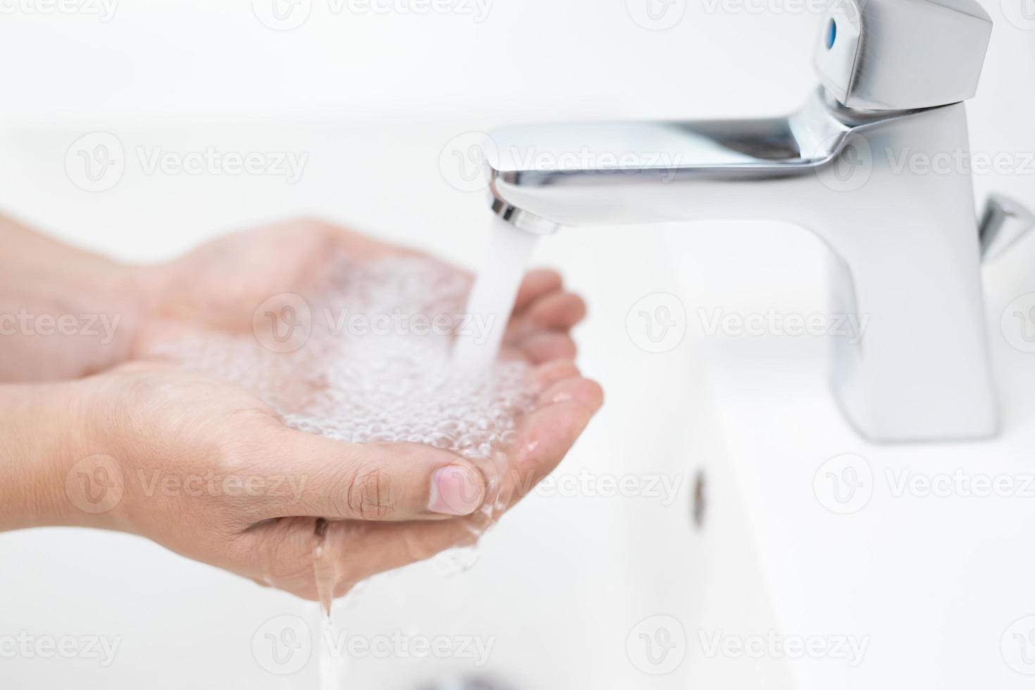 Cleaning Hands. Washing hands with soap under the faucet with water Pay dirt. photo