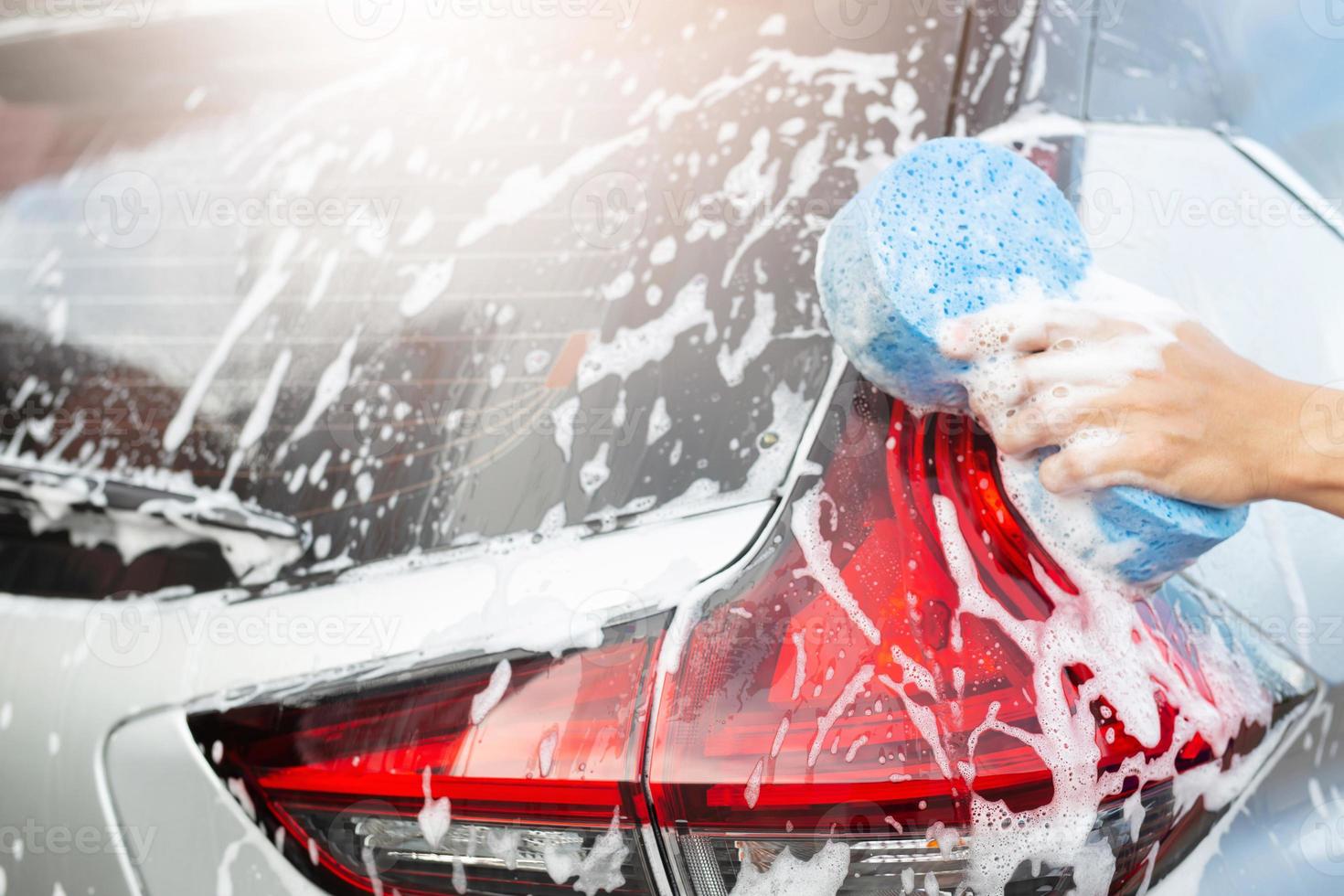 Outdoor car wash with foam soap. Stock Photo