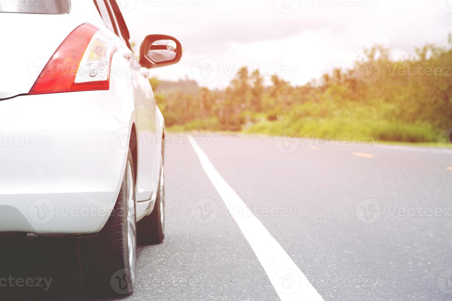 Car Parking in traffic lines on the roadside of country road on a background of green spring fields or meadow in outdoors. transportation journey travel concept. photo