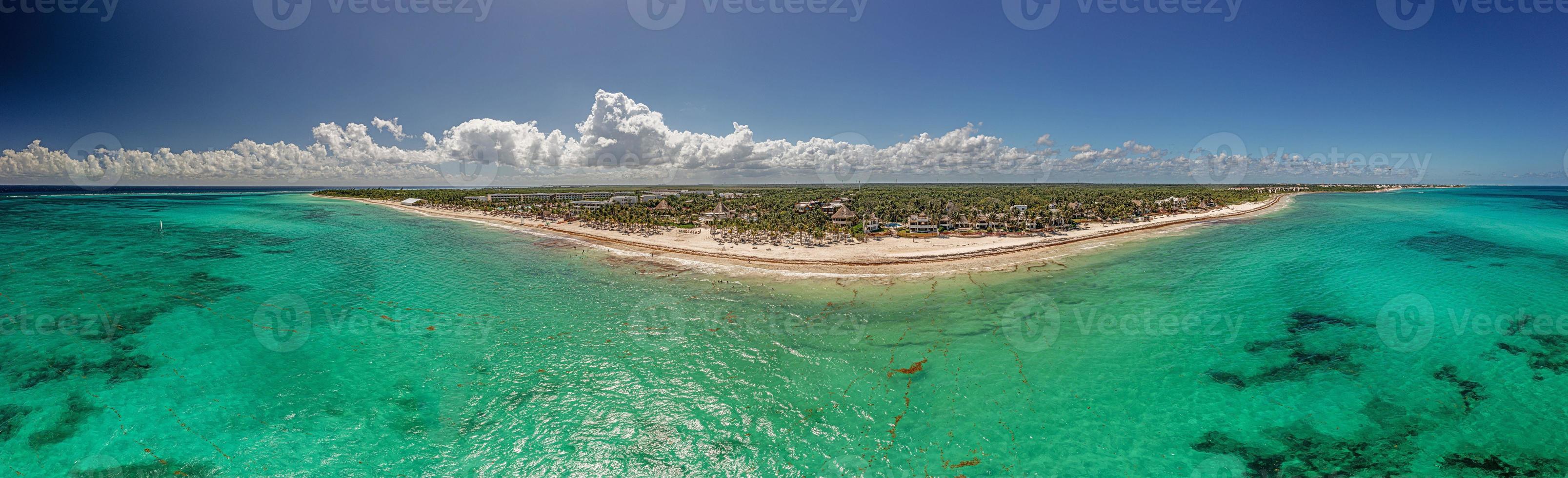 Panorama over a tropical beach taken from the water during the day photo