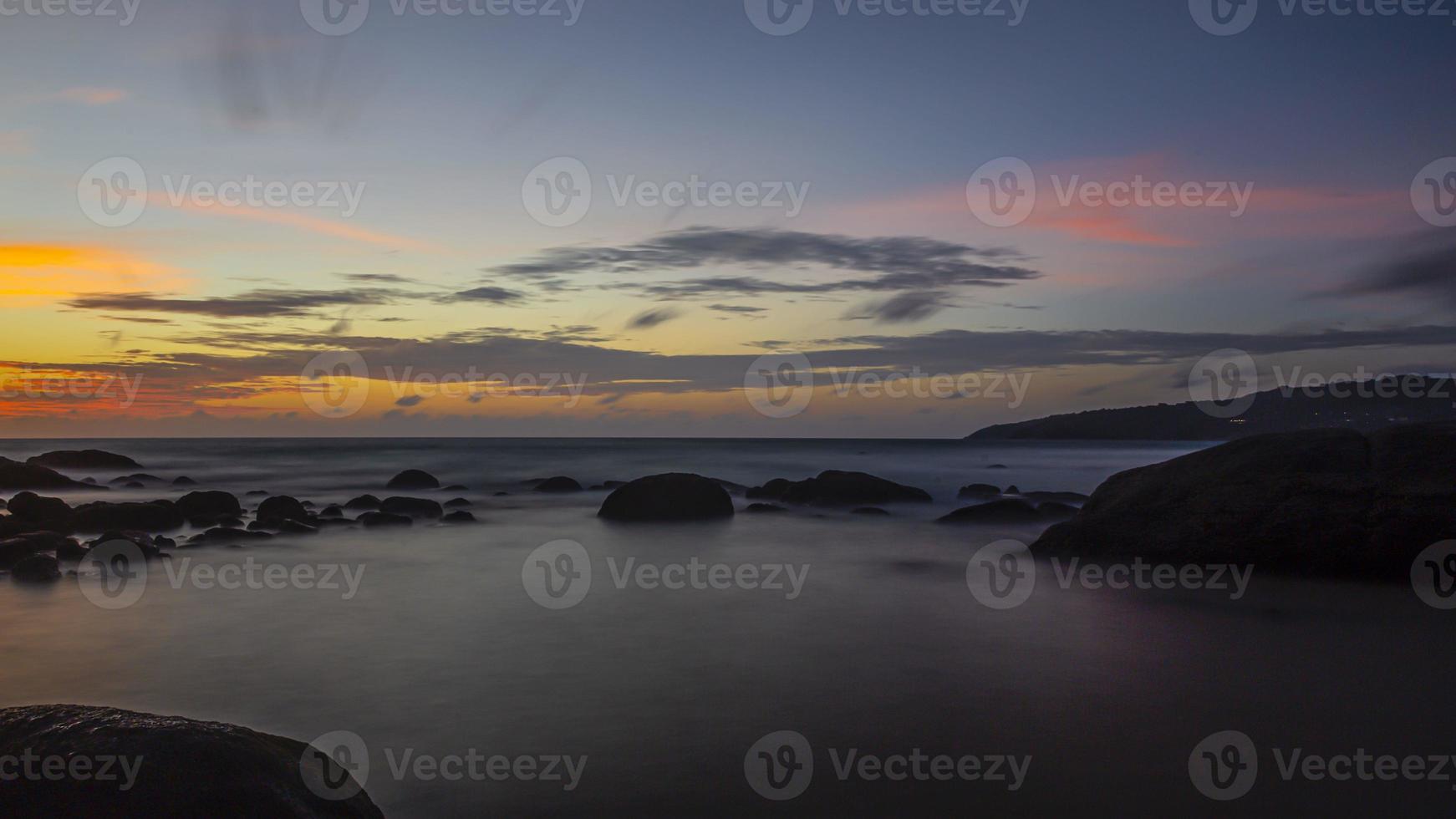 Long exposure picture of colorful sunset at Kamala beach in Thailand in summer photo