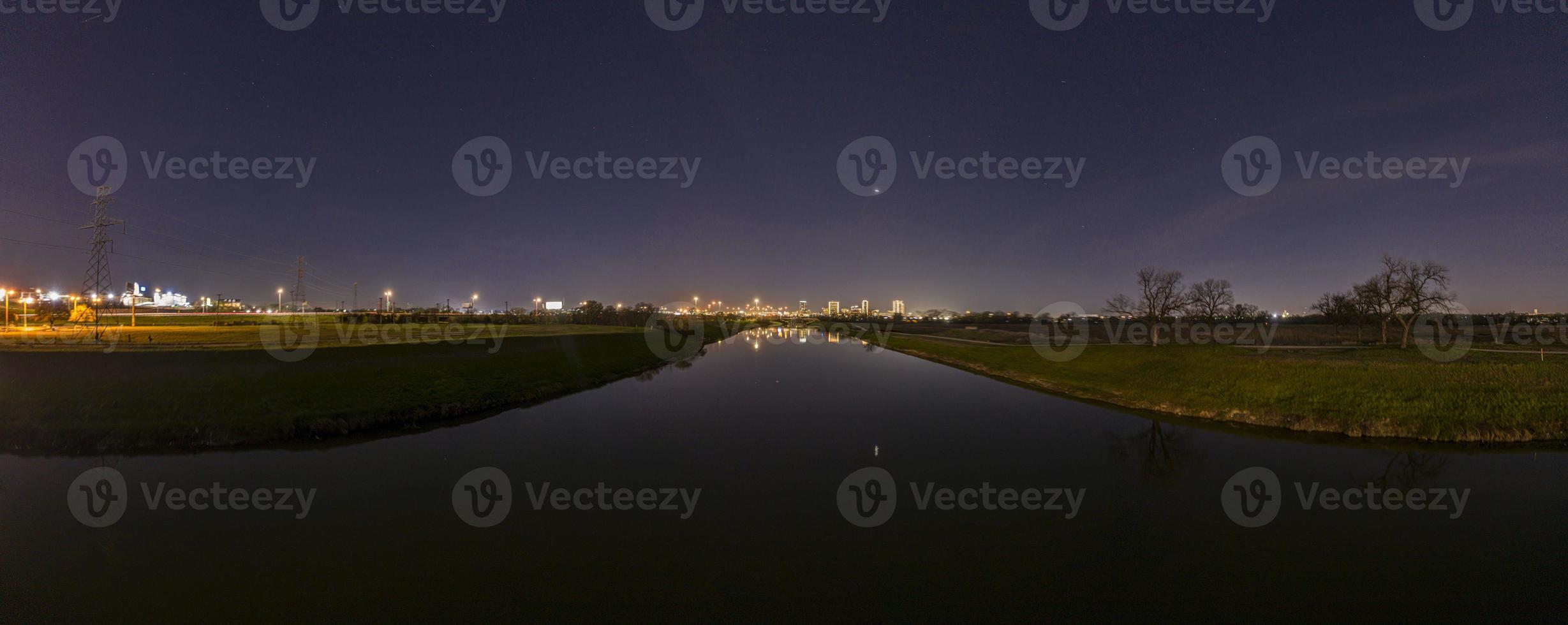 Panoramic aerial view on illuminated skyline of Fort Worth over West Fork Trinity River at night photo