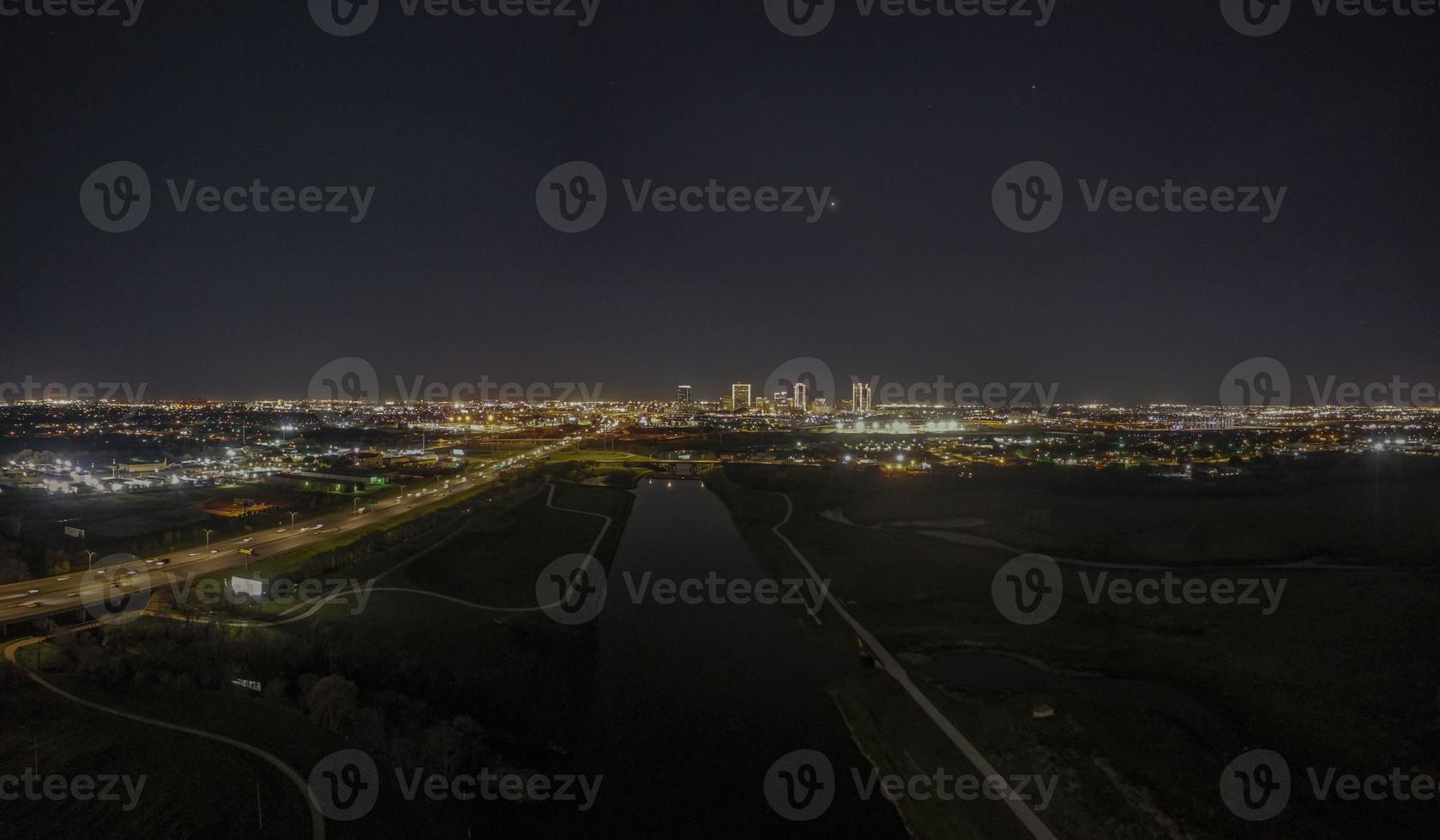 Panoramic aerial view on illuminated skyline of Fort Worth over West Fork Trinity River at night photo