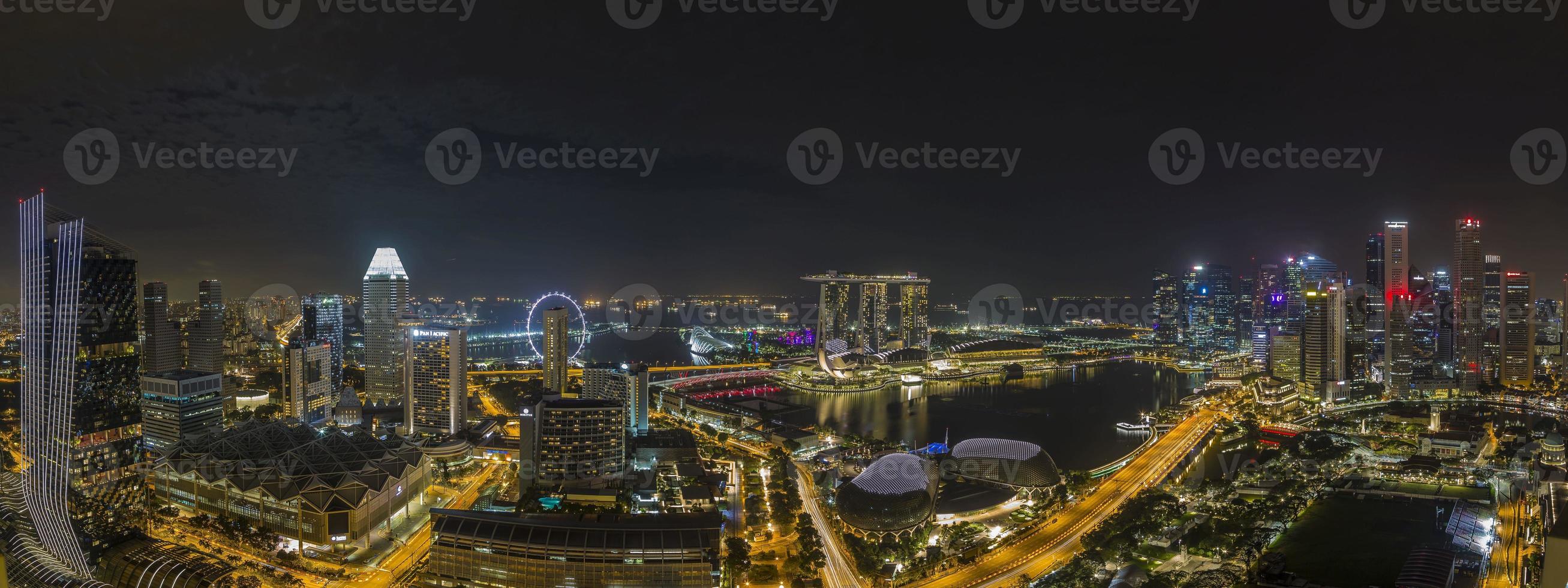 Aerial panoramic picture of Singapore skyline and gardens by the bay during preparation for Formula 1 race in the night in autumn photo