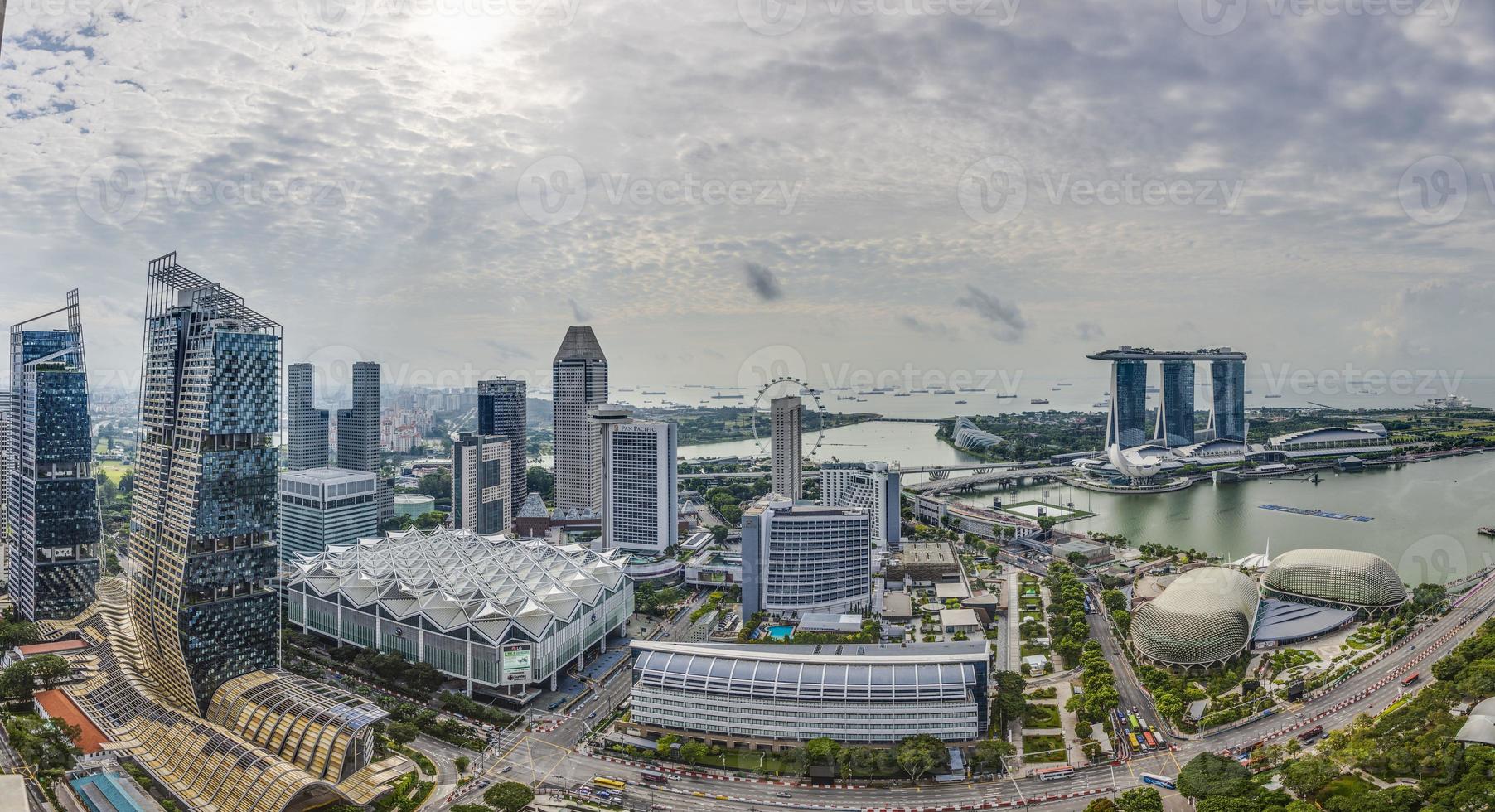 Aerial panoramic picture of Singapore skyline and gardens by the bay during preparation for Formula 1 race during daytime in autumn photo