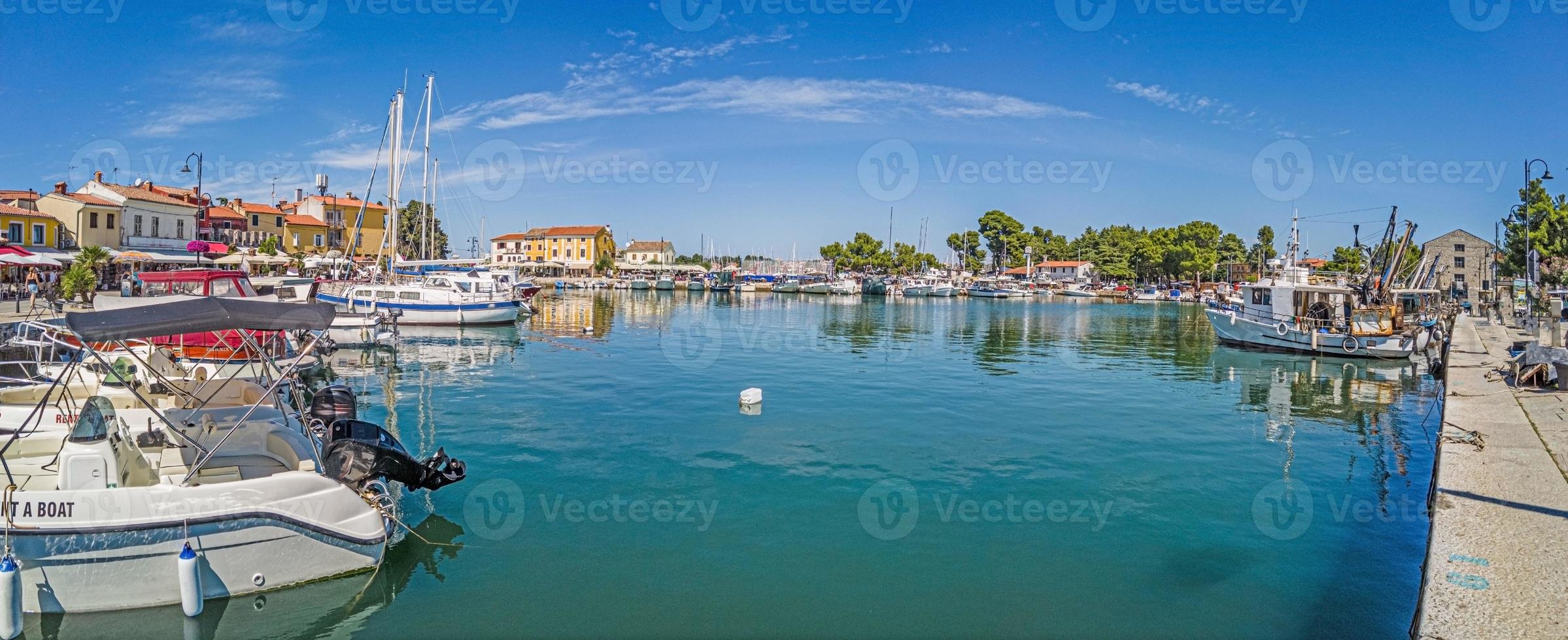 Panoramic view over the harbor of the Croatian coastal town of Novigrad in Istria during the day when the weather is clear photo