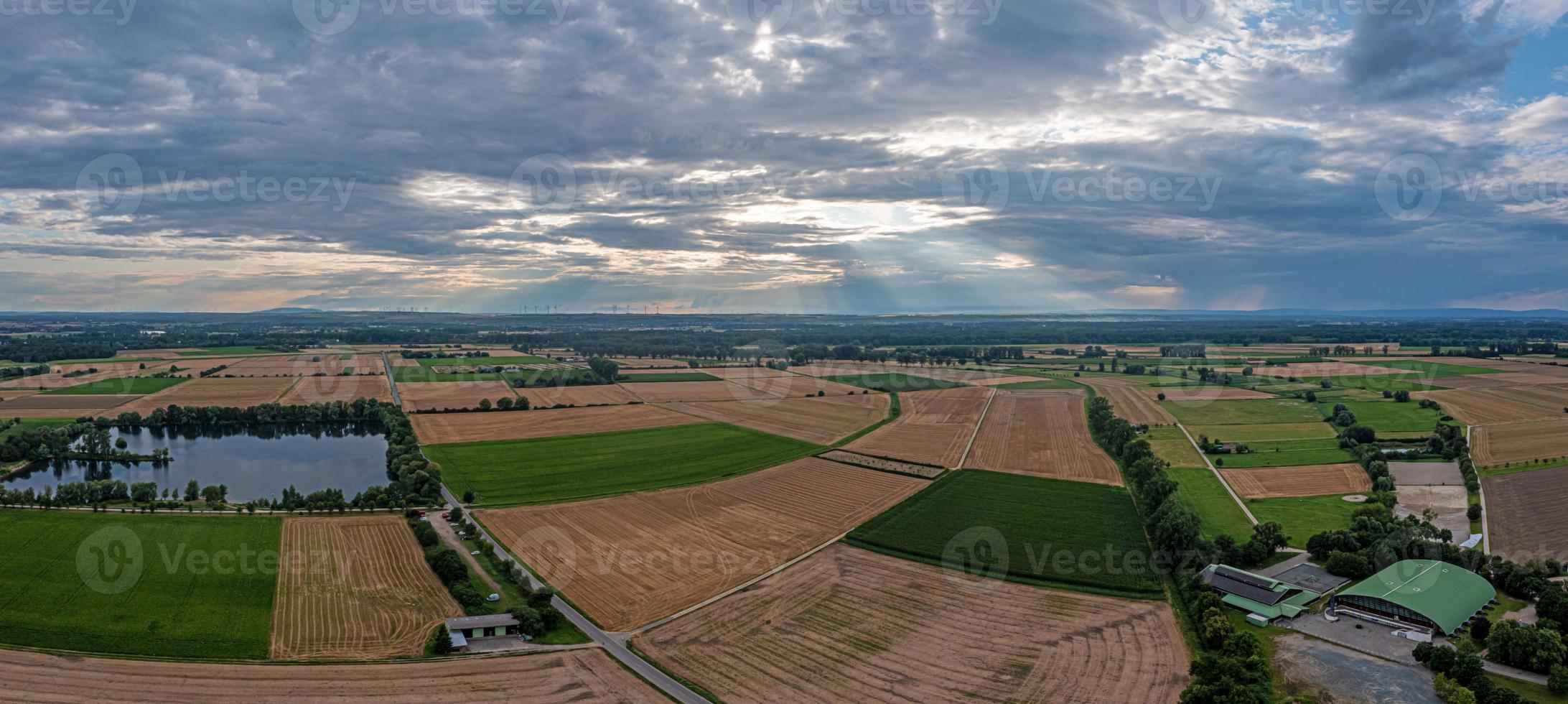 Drone panorama over Hessian fen with dramatic cloud formations and sun beams photo