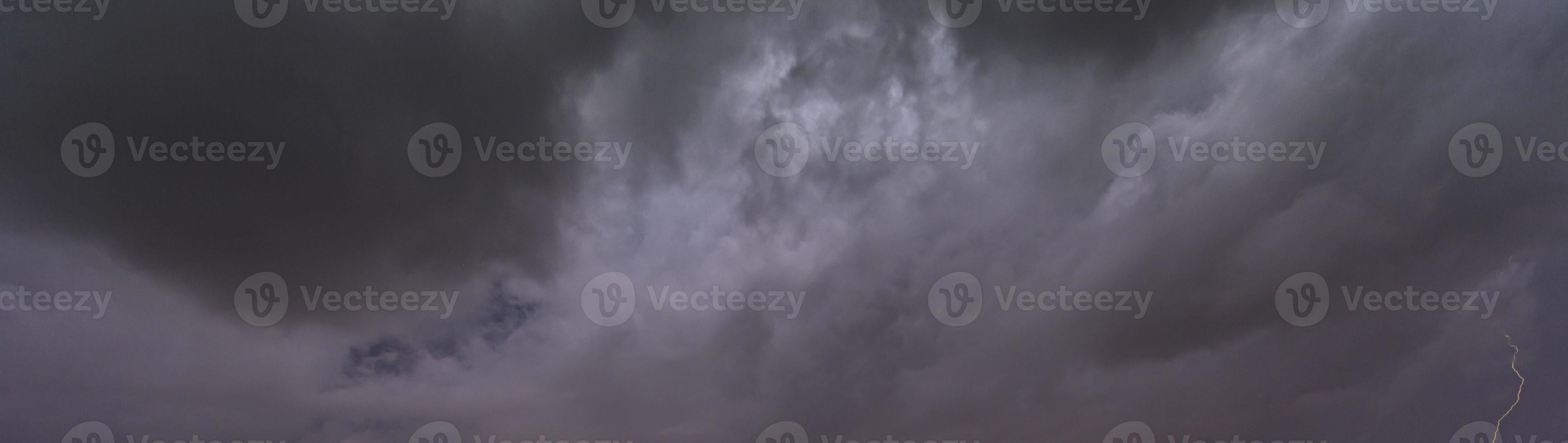 Picture of a flash in the night sky with glowing clouds photo