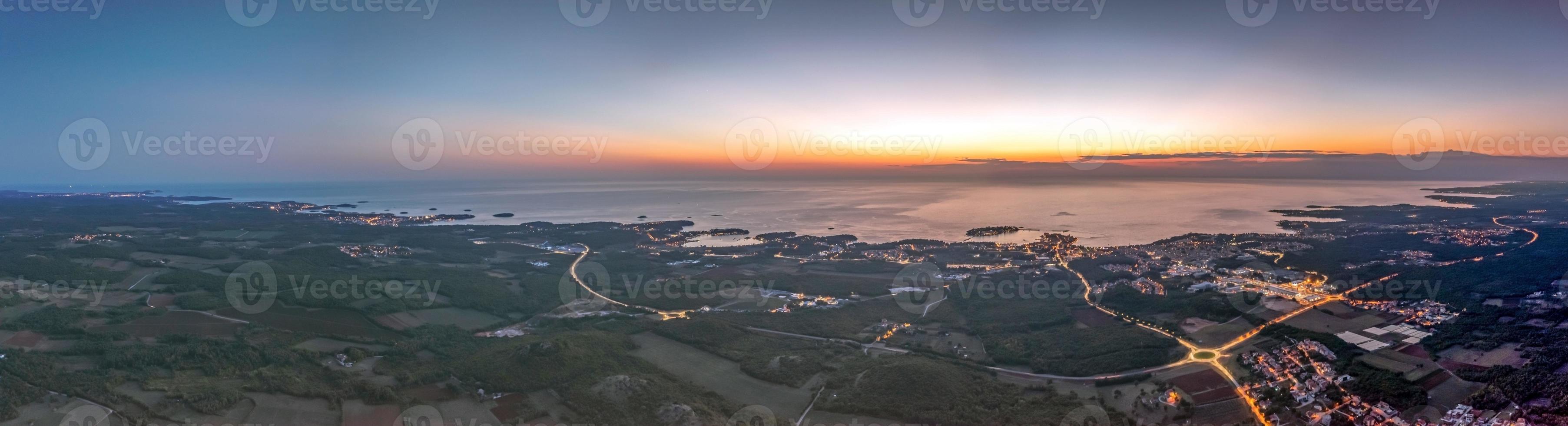 Drone panorama over Istrian Adriatic coast near Porec taken from high altitude at sunset photo