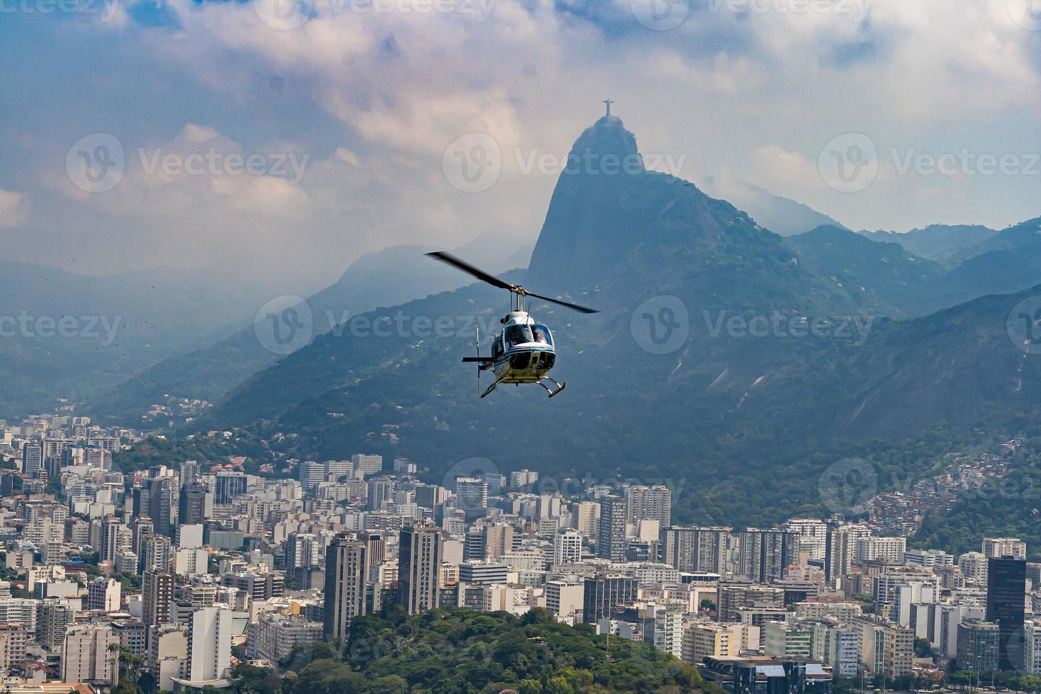 Panoramic view of the city and beaches from the observation deck on Sugarloaf Mountain in Rio de Janeiro with helicopter in flight photo