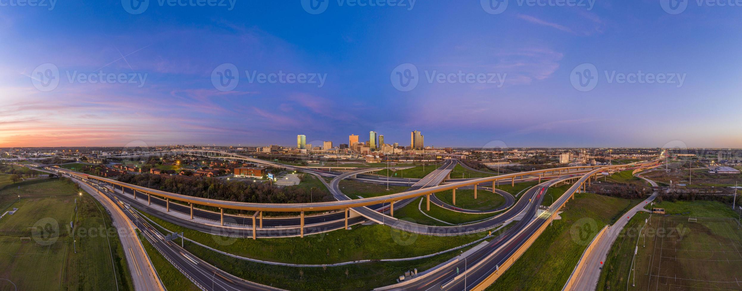 Aerial panorama picture of the Fort Worth skyline at sunrise with highway intersection in Texas photo