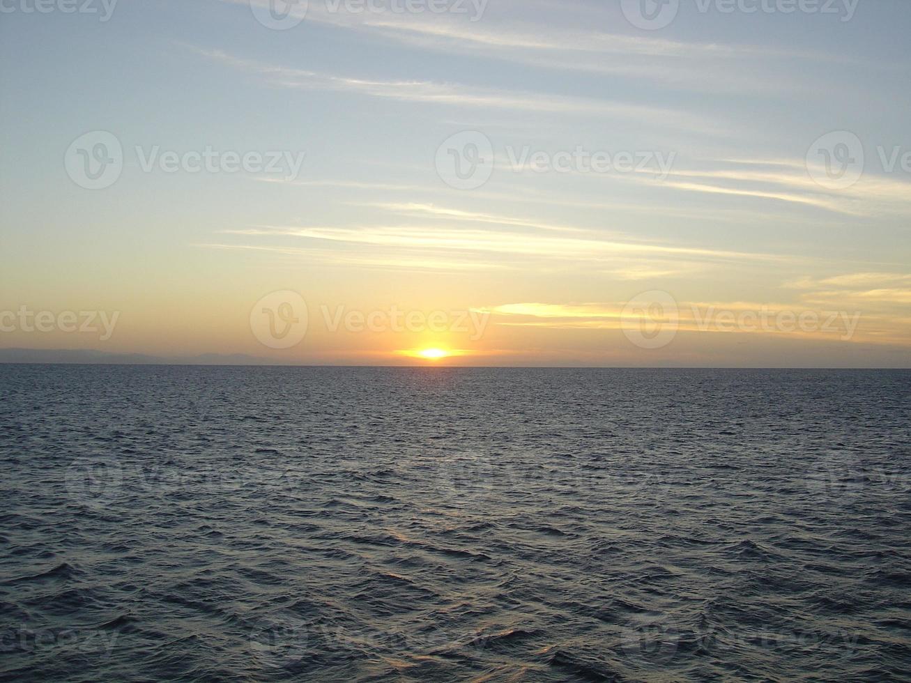 Image of sunset over the sea in clear weather photo