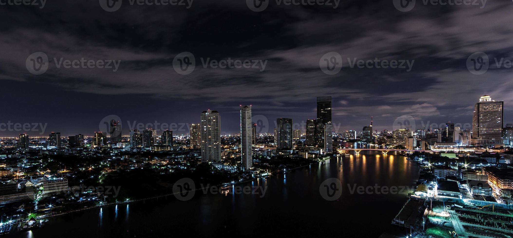 Panoramic aerial night picture of the Bangkok skyline and Chao Phraya river photo