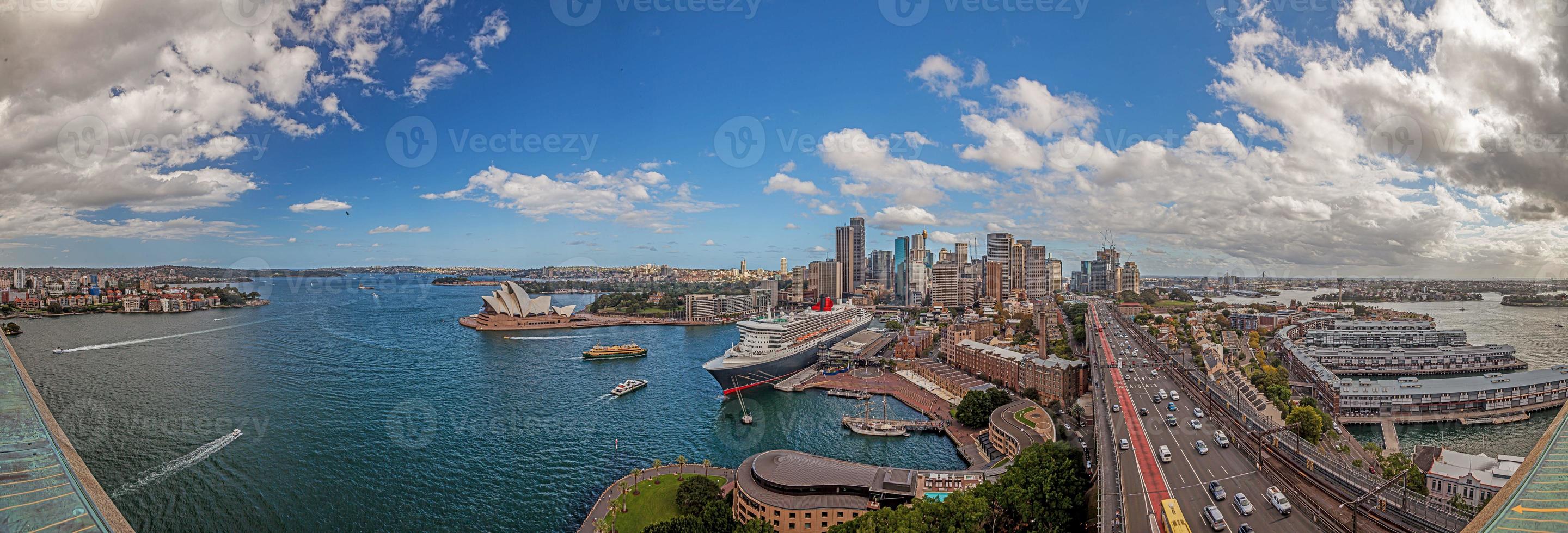 Aerial panoramic view of Sydney harbor from Harbor Bridge with skyline, opera house and cruise terminal photo