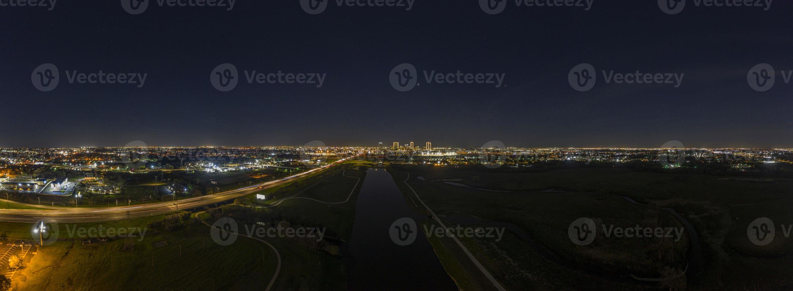 Panoramic aerial view on illuminated skyline of Fort Worth over West Fork Trinity River at night photo
