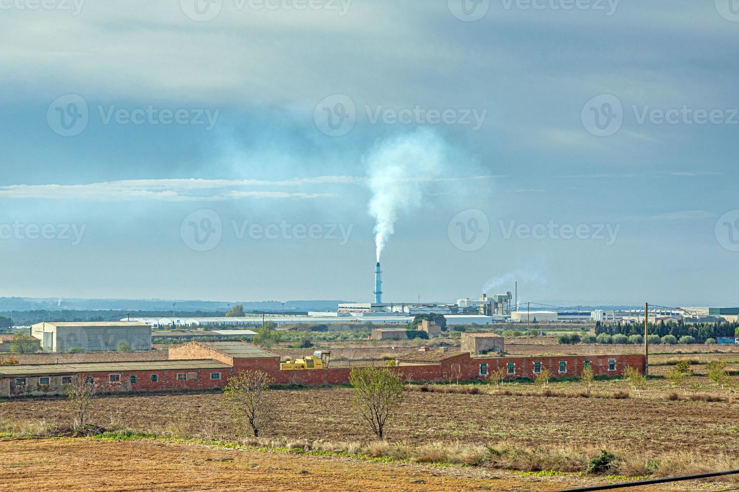 Image of a smoking chimney of a waste incineration plant photo