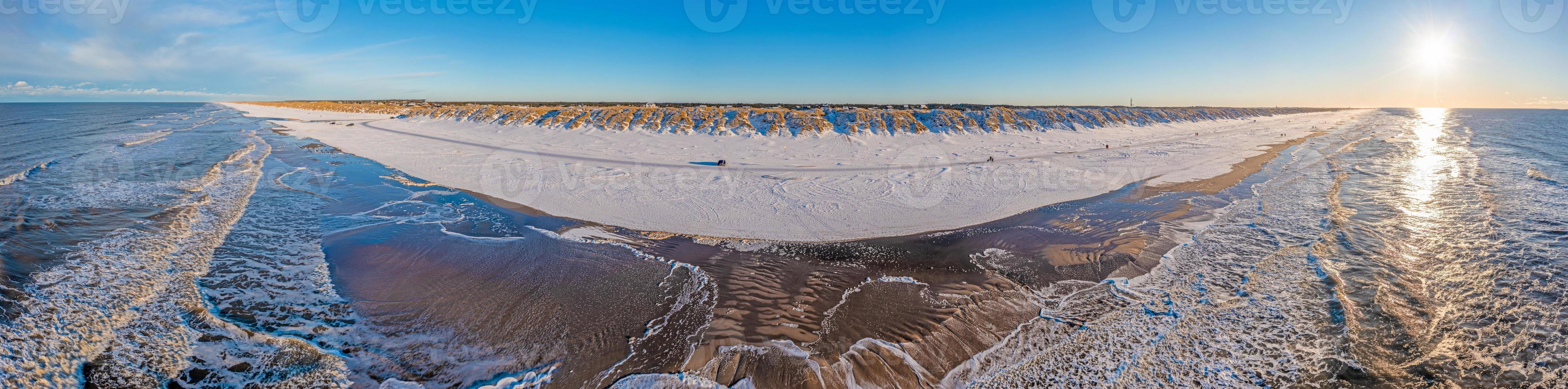 Drone panorama over Vejers beach in Denmark with sunshine and snow photo