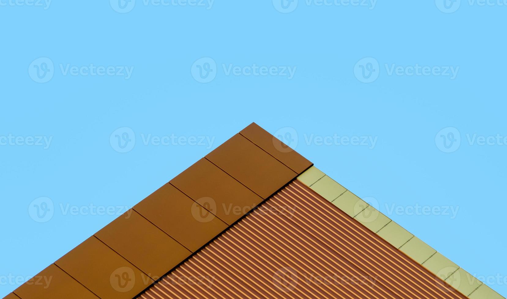 orange wall of a modern building against a blue sky photo