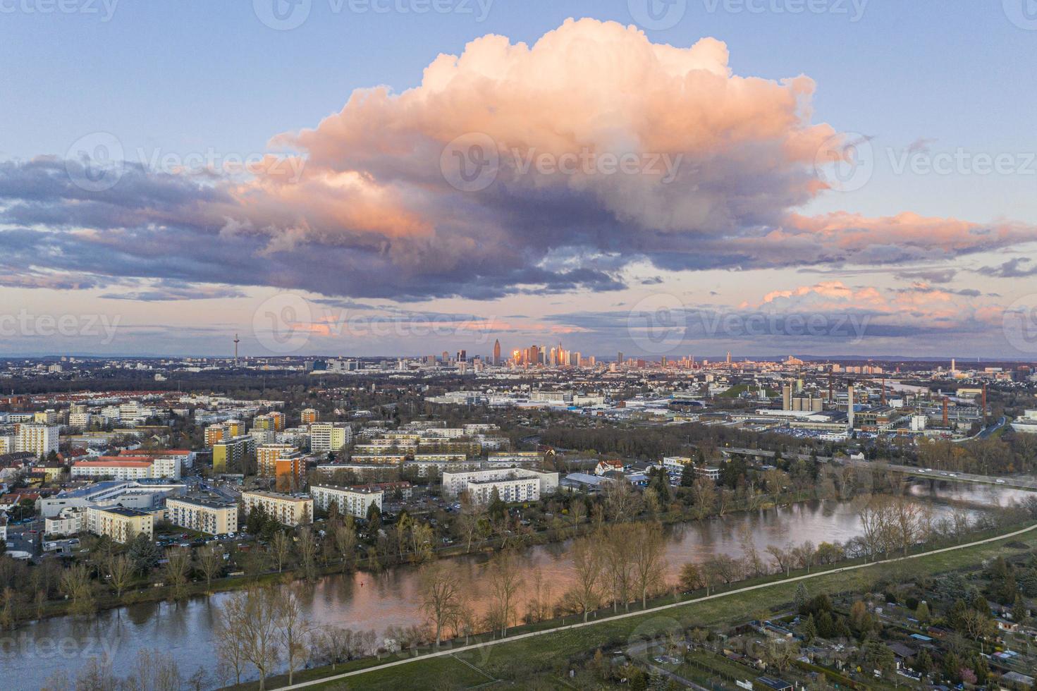 Aerial panoramic picture of river Main and the Frankfurt skyline during sunset in afterglow with illuminated cloud photo