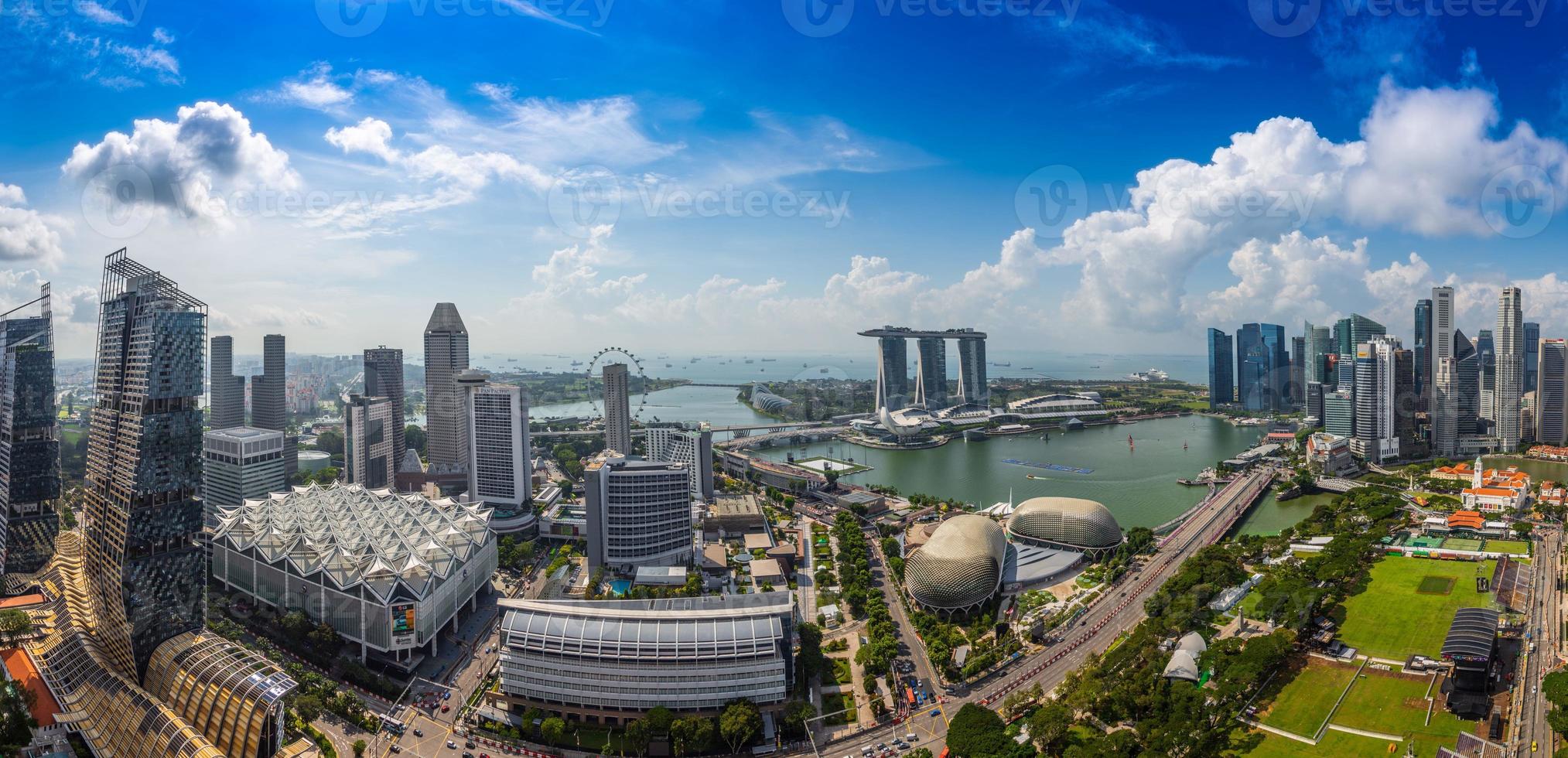 Aerial panoramic picture of Singapore skyline and gardens by the bay during preparation for Formula 1 race during daytime in autumn photo