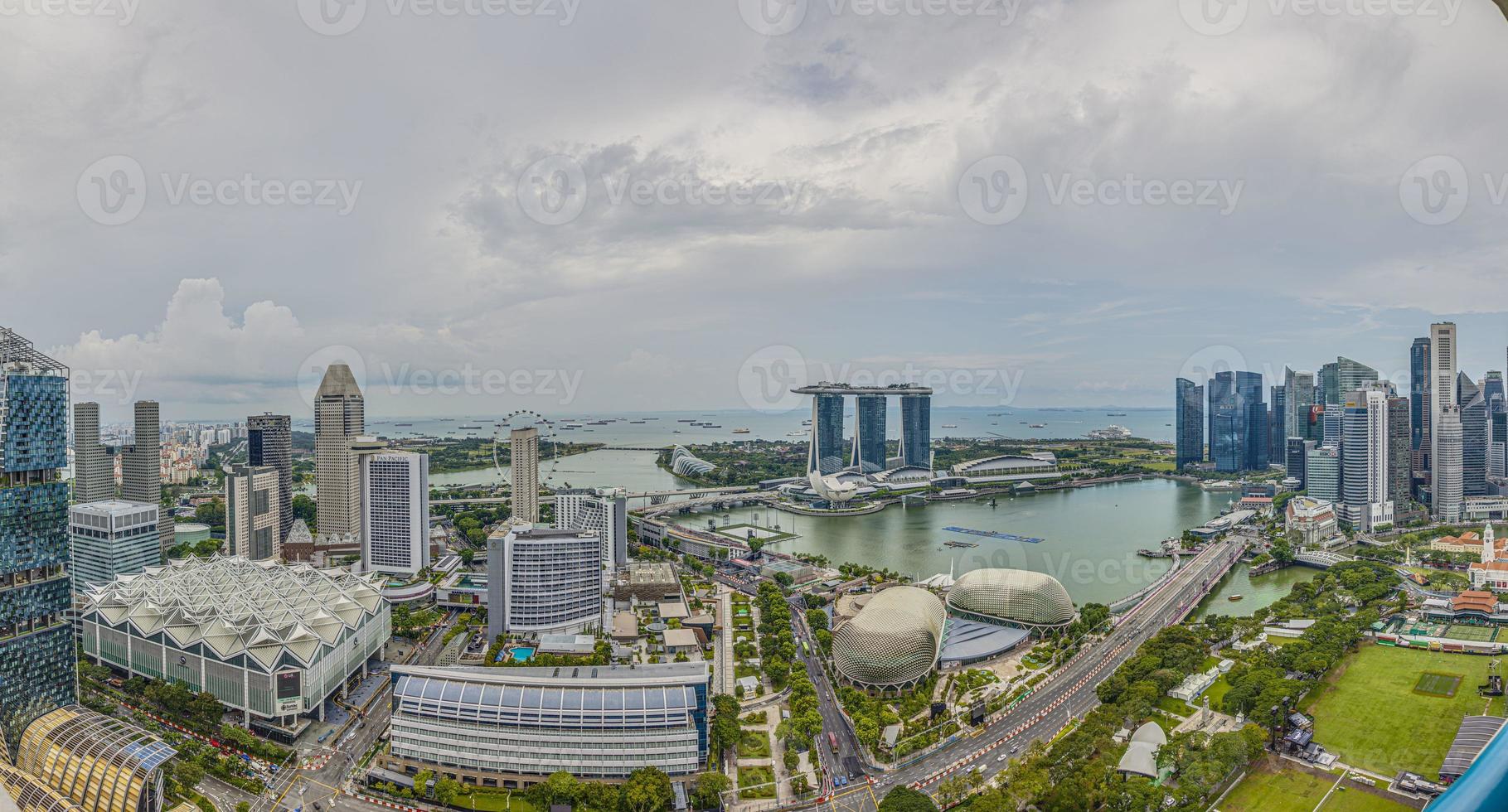 Aerial panoramic picture of Singapore skyline and gardens by the bay during preparation for Formula 1 race during daytime in autumn photo