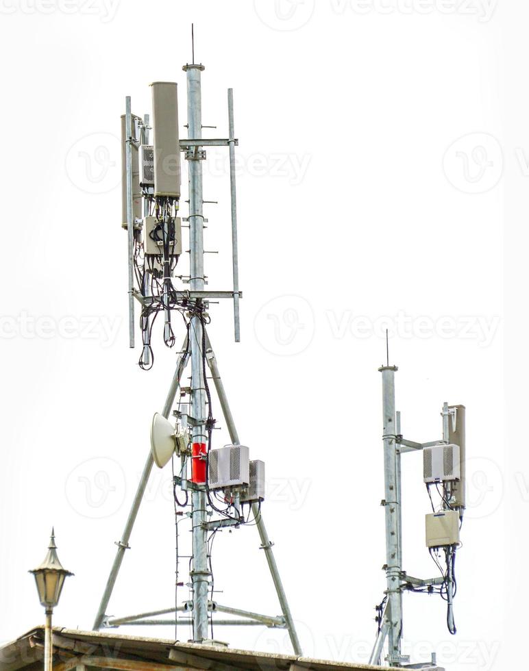 communication tower with antennas on the top of building isolate on white background photo