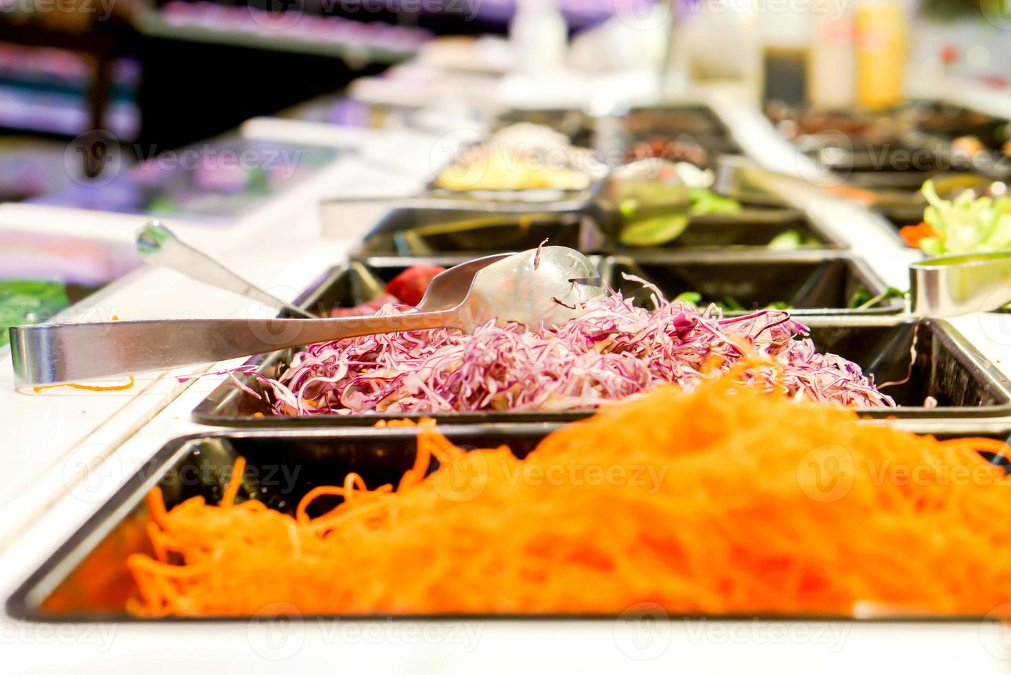 Freshly cut vegetables are lined up in a tray for sale as a vegetable salad in the supermarket. photo