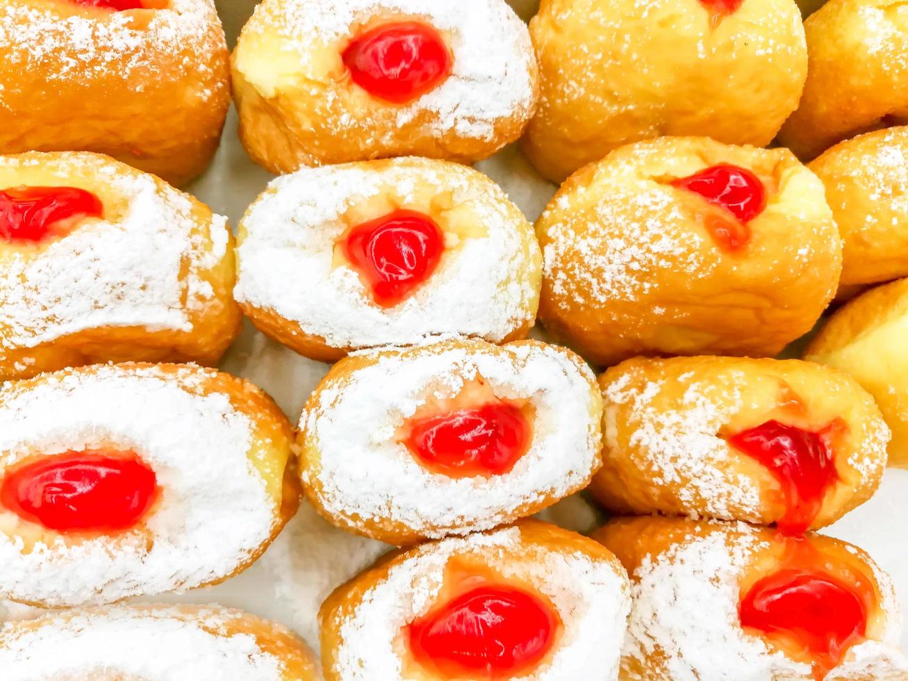 Image of Stuffed with strawberry jam doughnut crop to background and wallpaper. photo