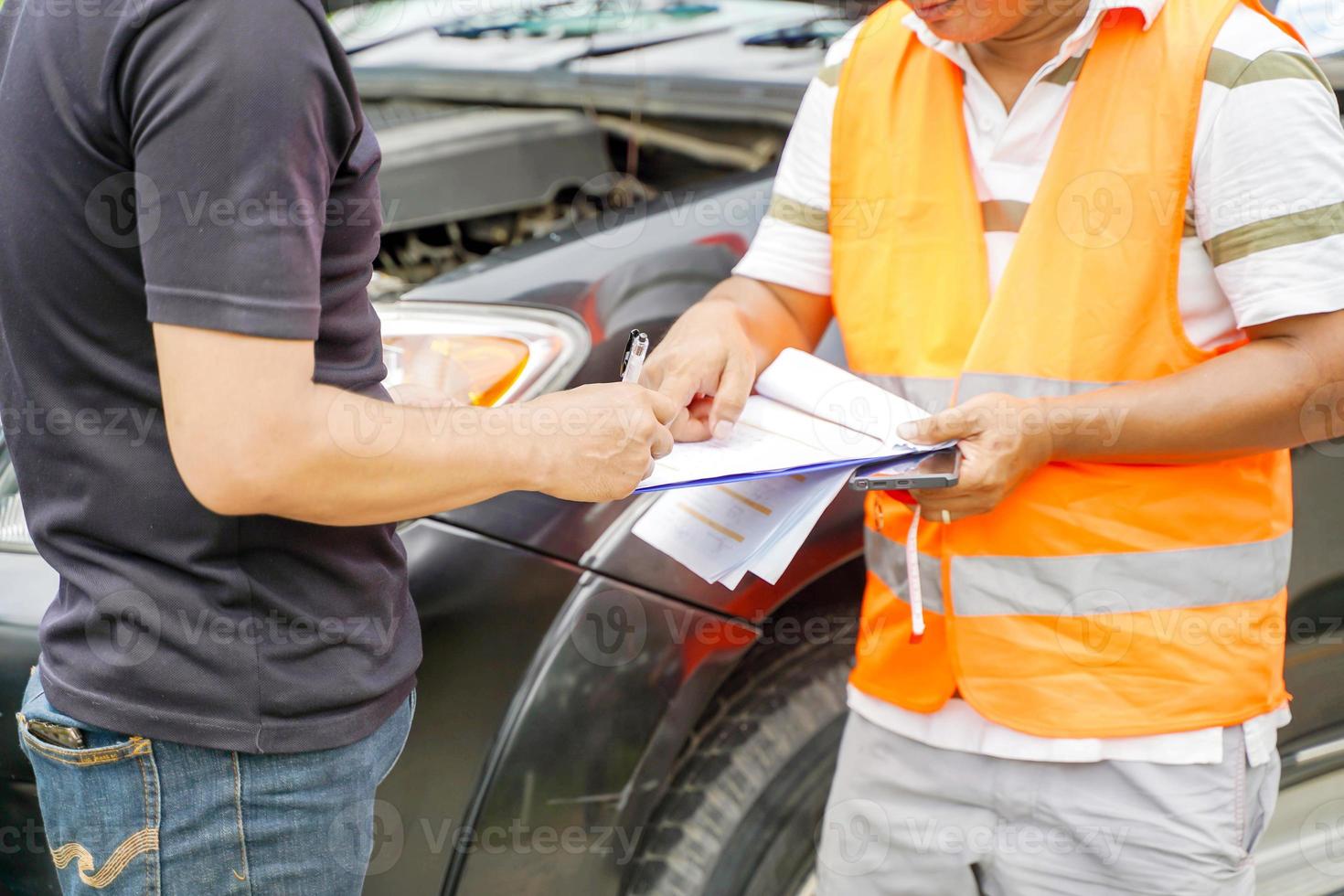 Closeup and crop traffic accident and insurance agent working on report form with car accident claim process. photo