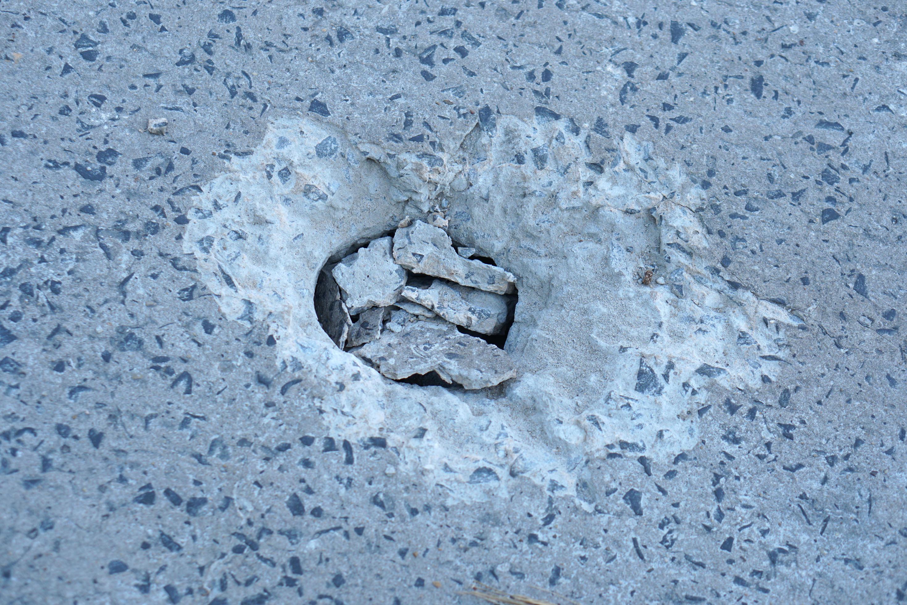 Holes are made by drilling from a machine for repairing concrete roads