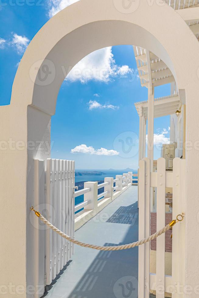 White architecture on Santorini island, Greece. Beautiful landscape, sea view. Summer travel and tourism concept, luxury hotel, resort concept. Private area, white entrance door and blue sky view photo