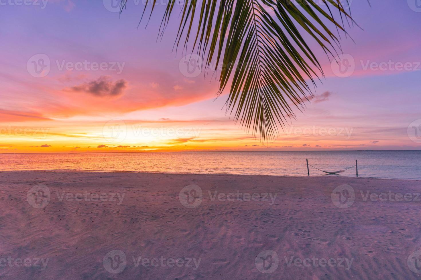 tranquila puesta de sol en la playa. hoja de palma con cielo colorido al atardecer. paisaje de verano, asombroso estado de ánimo pacífico. paisaje natural en la playa tropical. cielo de puesta de sol de arena de mar con horizonte, maravilloso paisaje paisajístico foto