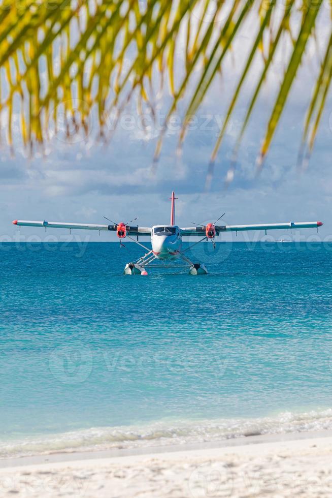 Sea plane at tropical beach resort. Luxury summer travel destination with seaplane in Maldives islands. Exotic vacation or holiday transportation, Maldives sea photo