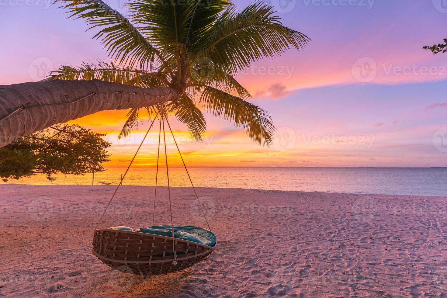 Tropical beach sunset as summer landscape with luxury resort beach palm swing hammock, sand seaside shore for sunset beach landscape. Tranquil beach horizon scenery vacation and summer holiday concept photo