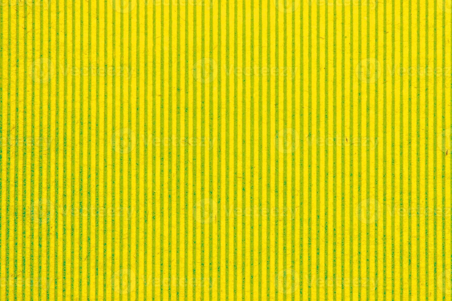 Abstract paper yellow geometric symmetrical texture striped surface vertical lines background. Structure design cardboard shape backdrop. Holiday spring decoration interior concept. Flatlay, close-up photo