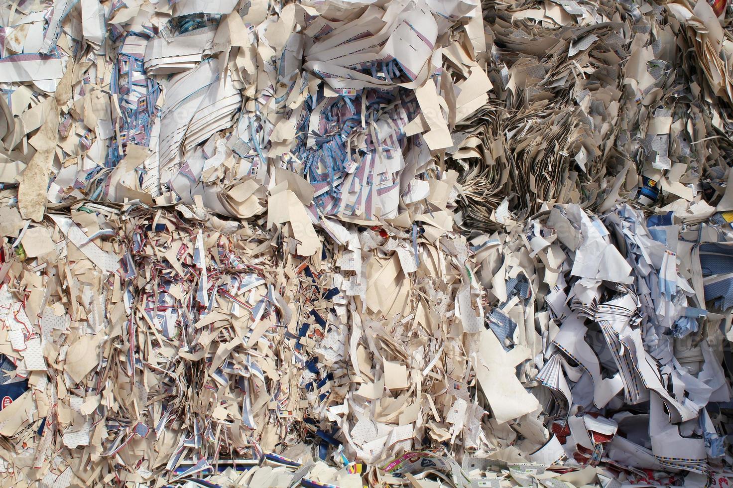 Waste pile for recycling on sorting plant. Technology reuse materials. Stack of shredded paper. Save the planet ecology concept. Industry reduced pollution factory photo