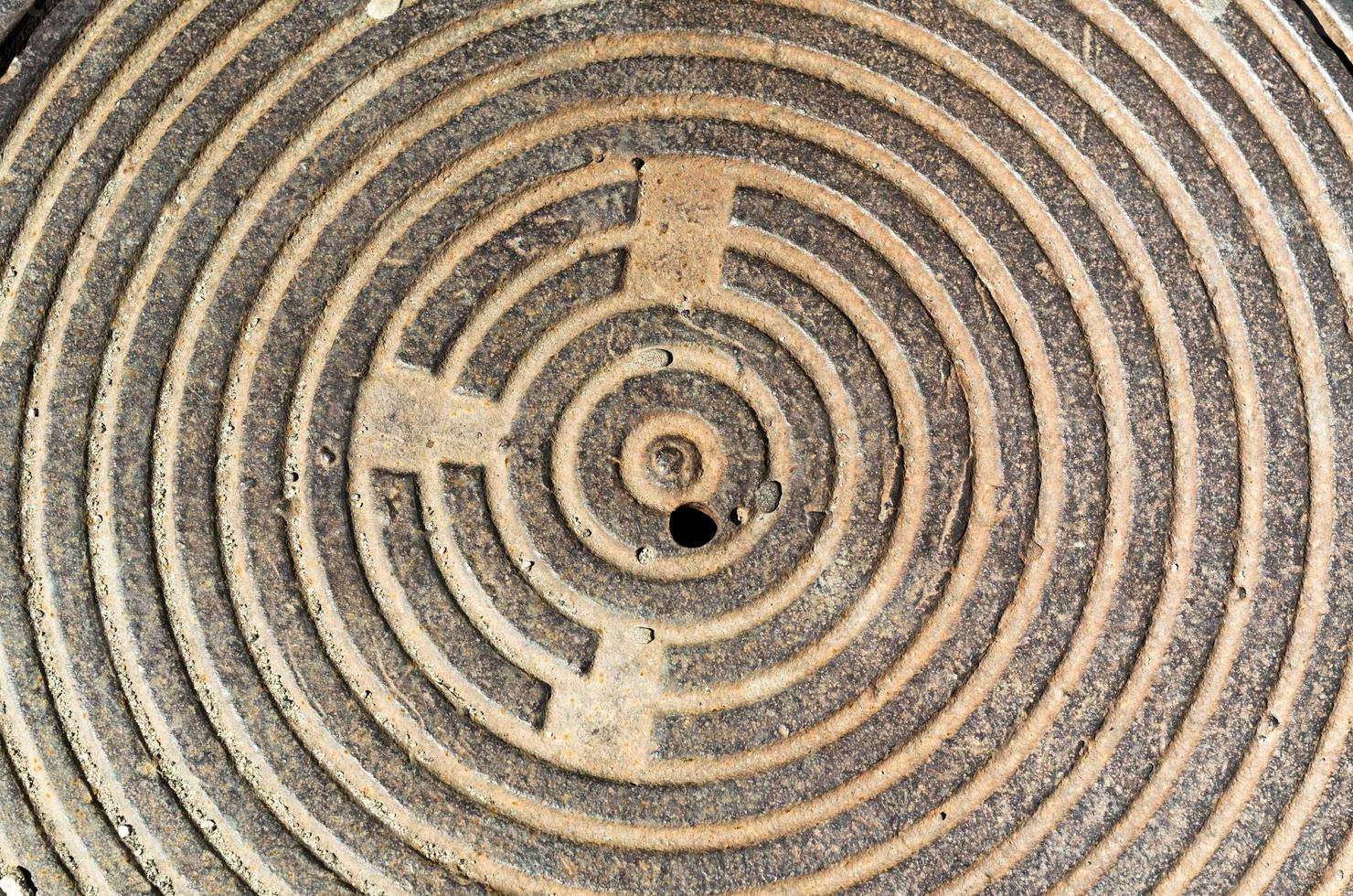 concentric round texture cast-iron hatch cover of brown rusty co photo