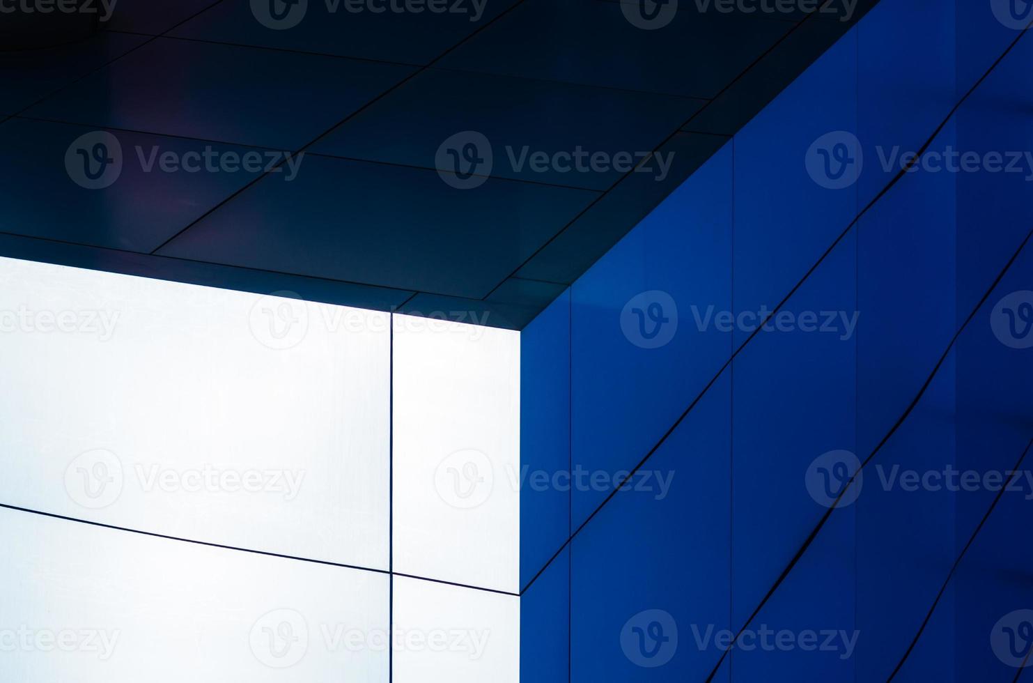 fragment of the wall of a modern blue building on a white background photo