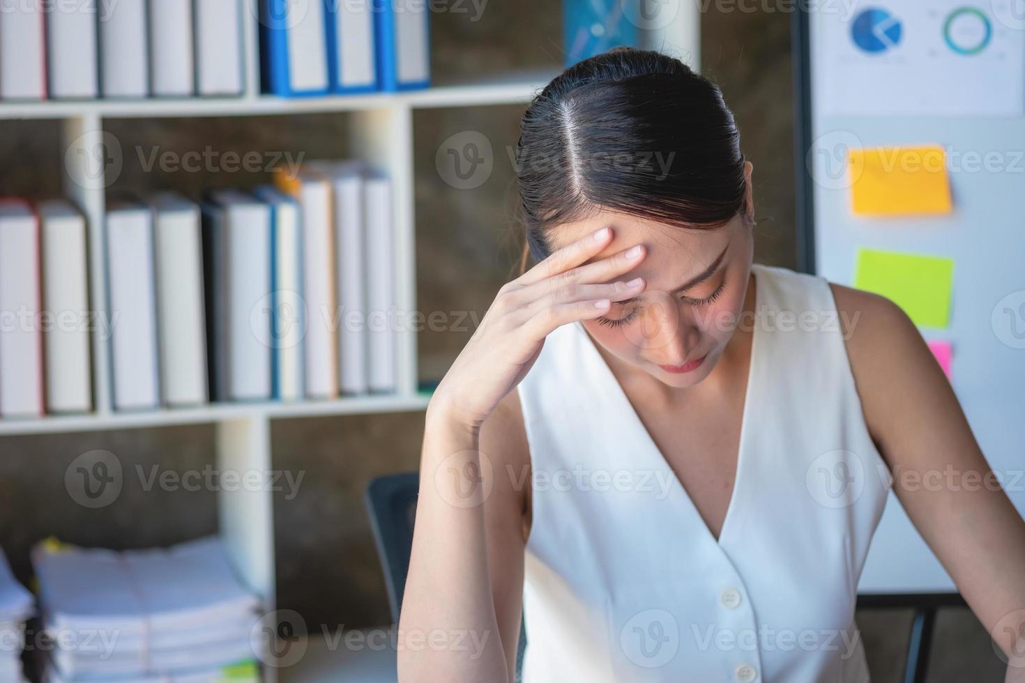 Concept Burnout Syndrome. Business Woman feels uncomfortable working. Which is caused by stress, accumulated from unsuccessful work And less resting body. Consult a specialist psychiatrist. photo
