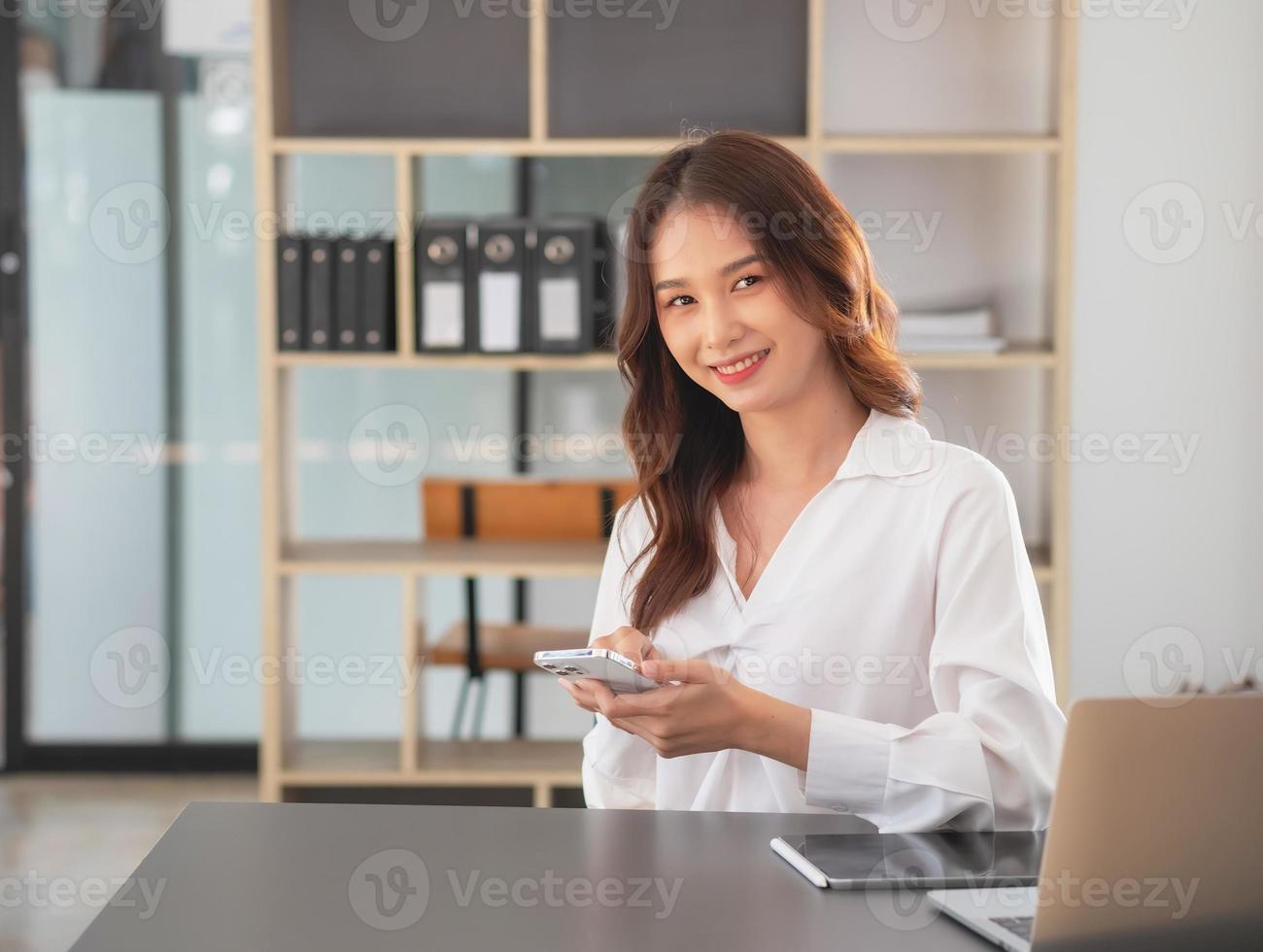 Marketing, Financial, Accounting, Planning, businesswomen uses a mobile phone to contact a customer to inform her of the company is business partnership. photo