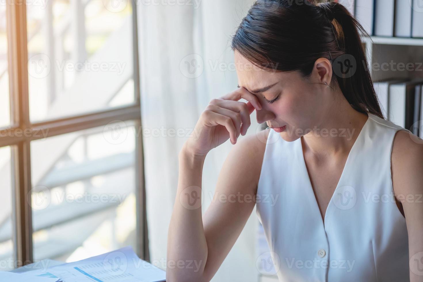 Concept Burnout Syndrome. Business Woman feels uncomfortable working. Which is caused by stress, accumulated from unsuccessful work And less resting body. Consult a specialist psychiatrist. photo
