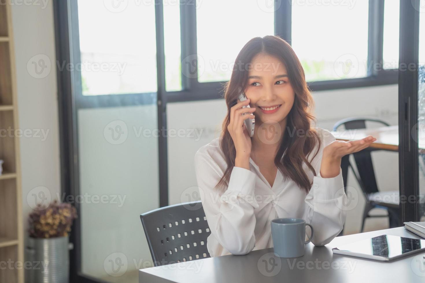 Marketing, Financial, Accounting, Planning, businesswomen uses a mobile phone to contact a customer to inform her of the company is business partnership. photo